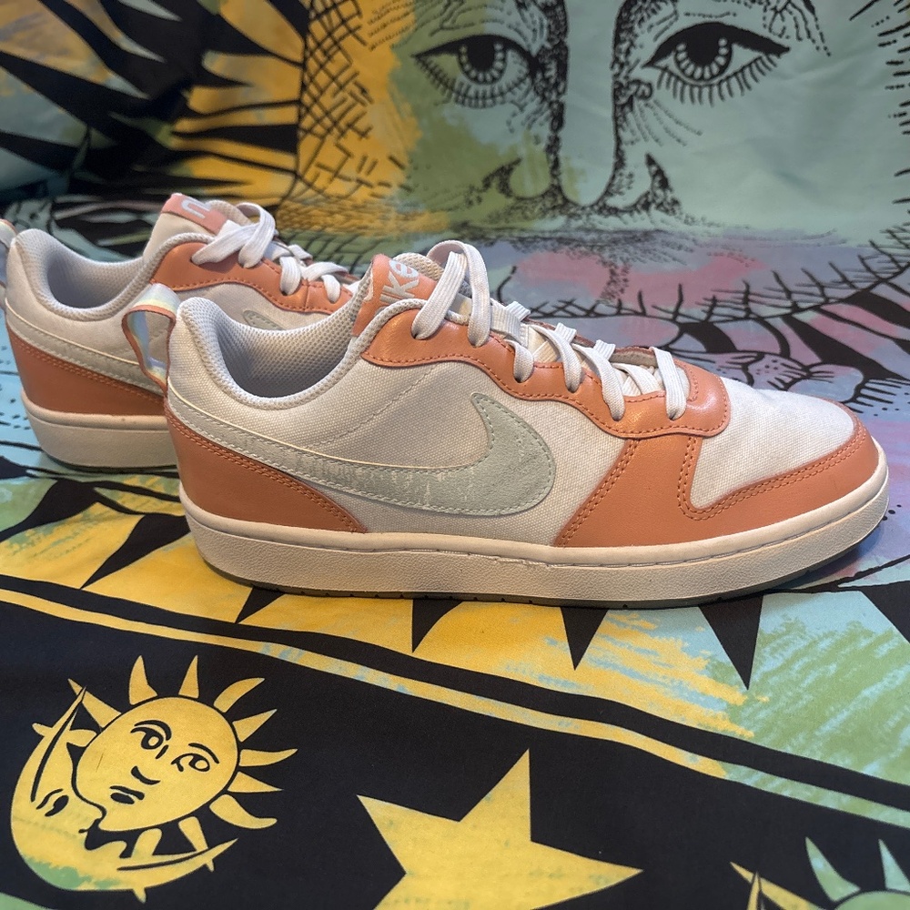 Nike Women’s Low-Top Sneakers in Peach and White with light blue Swoosh